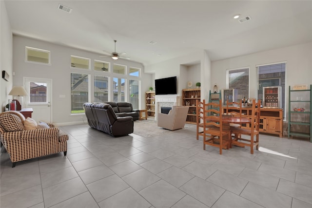 living room featuring light tile patterned floors and ceiling fan