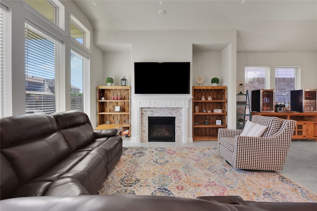 living room with a fireplace and light tile patterned floors