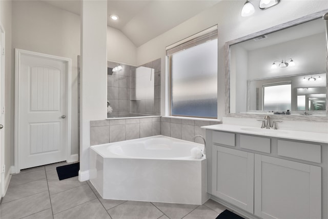 bathroom with vanity, lofted ceiling, tile patterned flooring, and separate shower and tub