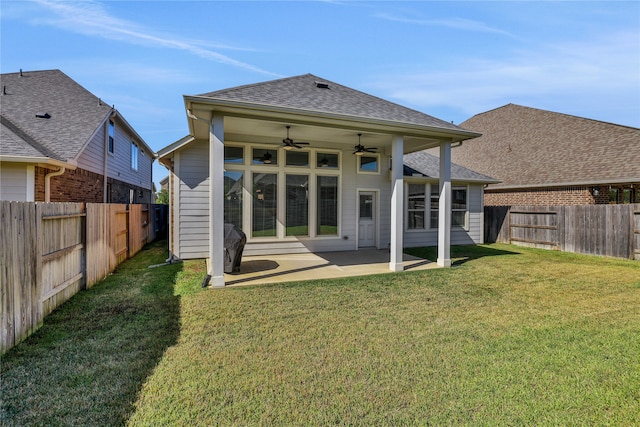 back of property with a patio, a lawn, and ceiling fan