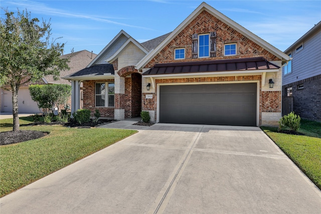 view of front of home featuring a front yard and a garage