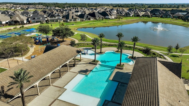 view of swimming pool featuring a patio and a water view