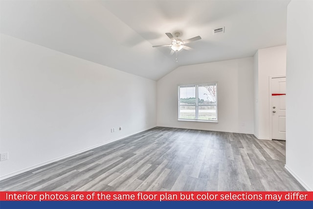 spare room with light hardwood / wood-style floors, vaulted ceiling, and ceiling fan