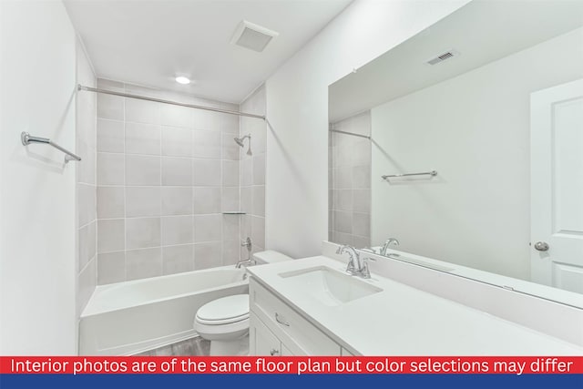 full bathroom featuring toilet, tiled shower / bath combo, and vanity