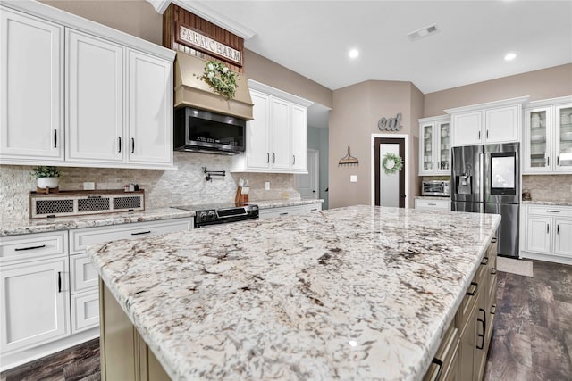 kitchen featuring white cabinetry, appliances with stainless steel finishes, dark wood-type flooring, and a kitchen island