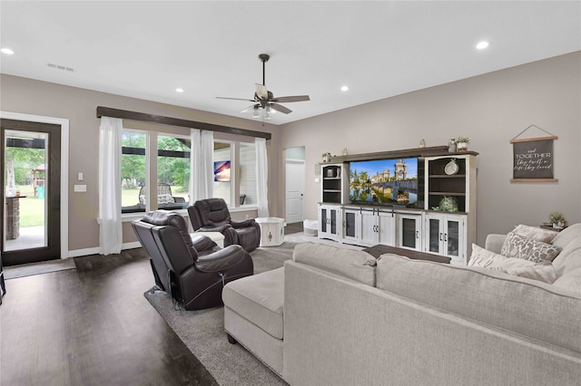 living room with dark wood-type flooring and ceiling fan