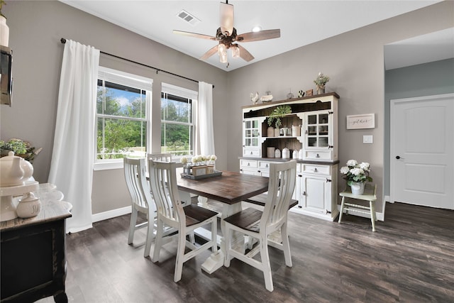 dining space with dark wood-type flooring and ceiling fan