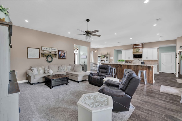 living room with hardwood / wood-style flooring and ceiling fan