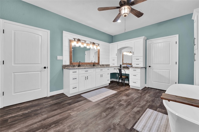 bathroom featuring a bath, vanity, hardwood / wood-style flooring, and ceiling fan