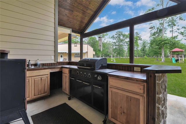 view of patio featuring sink, a gazebo, and exterior kitchen