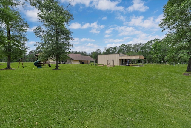 view of yard featuring a playground and an outdoor structure