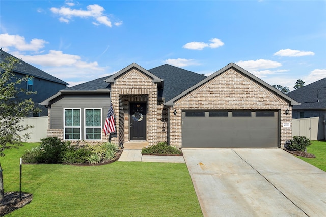 view of front of home featuring a garage and a front yard