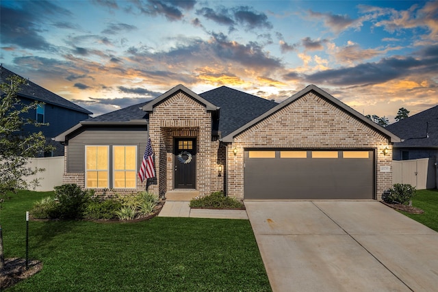 view of front facade with a lawn and a garage