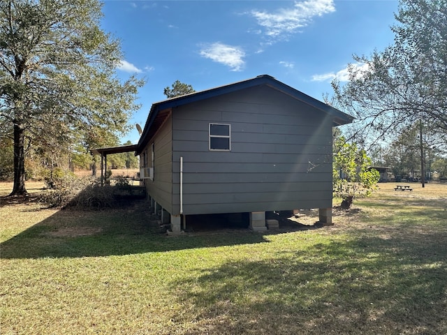 view of side of home featuring a yard