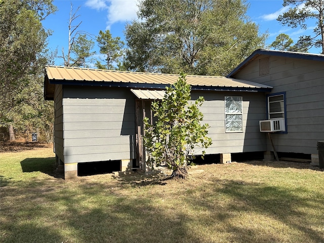 back of property featuring cooling unit and a lawn