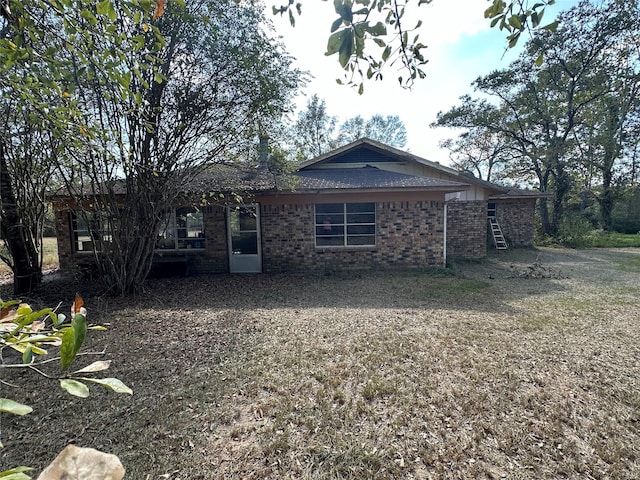 rear view of property with a lawn