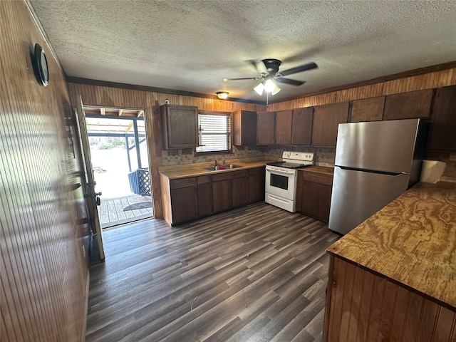 kitchen featuring stainless steel refrigerator, white electric stove, sink, dark hardwood / wood-style flooring, and dark brown cabinets