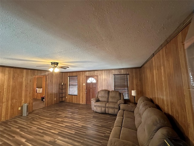 unfurnished living room with hardwood / wood-style floors, wooden walls, and a textured ceiling