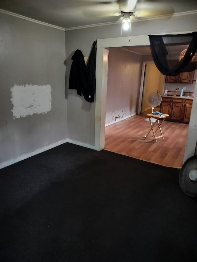 empty room featuring hardwood / wood-style floors, ceiling fan, and crown molding