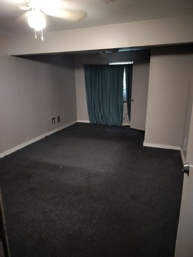 basement featuring ceiling fan and carpet floors