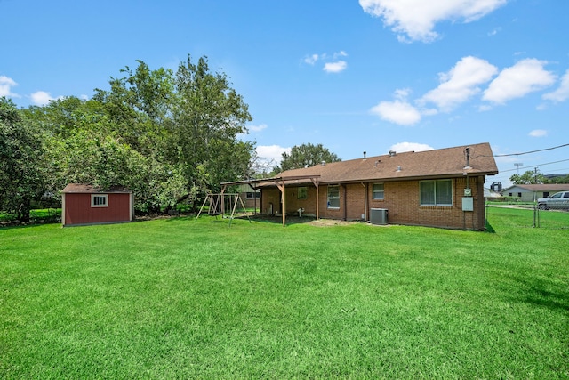 view of yard featuring central AC unit, a playground, and a shed