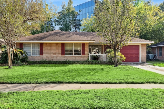 single story home featuring central AC, a garage, and a front lawn