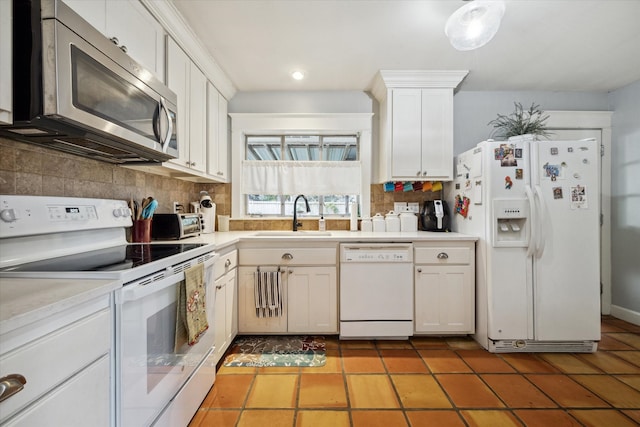 kitchen with white cabinets, white appliances, tasteful backsplash, and sink