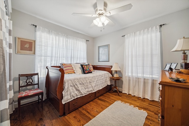 bedroom with ceiling fan and dark hardwood / wood-style floors