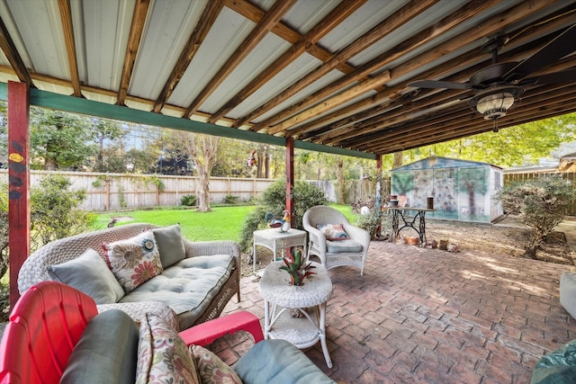 view of patio / terrace featuring ceiling fan, a shed, and an outdoor hangout area