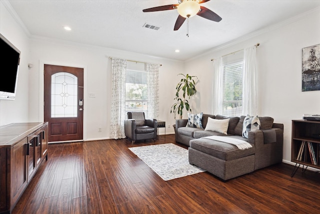 living room featuring ceiling fan, dark hardwood / wood-style flooring, and ornamental molding