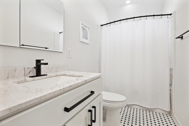 bathroom with toilet, vanity, and a shower with curtain