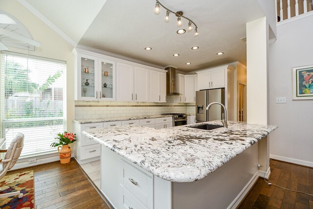 kitchen featuring sink, wood-type flooring, and white cabinets