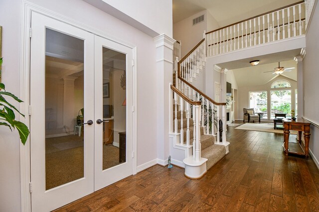 foyer featuring dark hardwood / wood-style flooring, french doors, vaulted ceiling, and ceiling fan