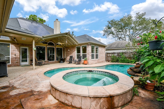 view of swimming pool featuring a patio, area for grilling, ceiling fan, and an in ground hot tub