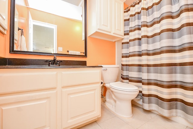 bathroom featuring vanity, tile patterned flooring, and toilet