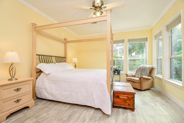 bedroom with light hardwood / wood-style floors, ceiling fan, and ornamental molding