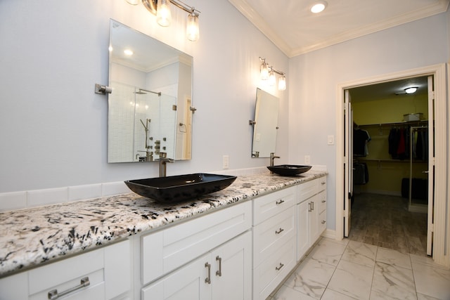 bathroom featuring vanity, an enclosed shower, and crown molding