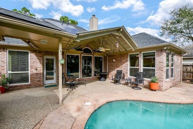 rear view of house featuring ceiling fan and a patio area