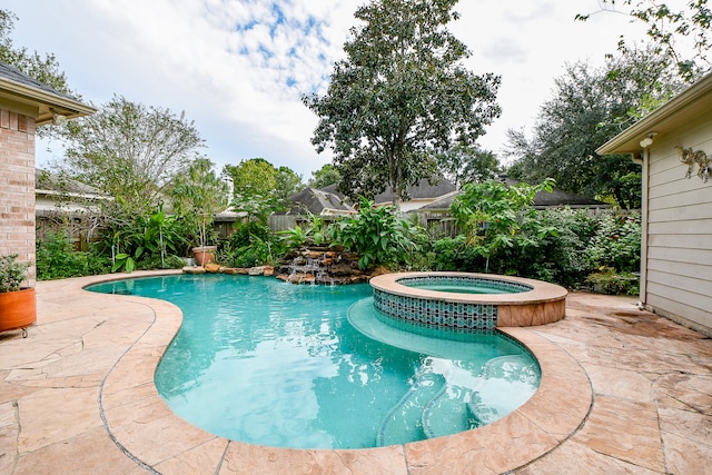 view of swimming pool with a patio and an in ground hot tub