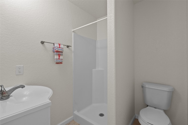 bathroom with toilet, a shower, and sink