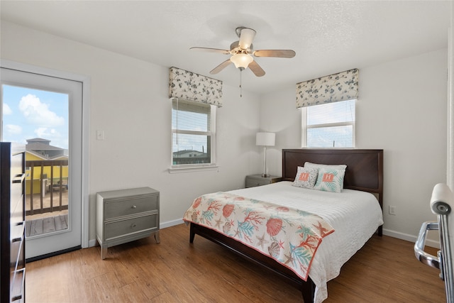 bedroom featuring access to outside, ceiling fan, and wood-type flooring