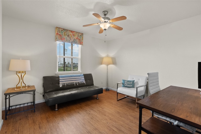 living area featuring ceiling fan and light hardwood / wood-style flooring