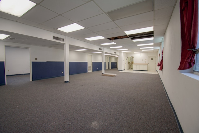 empty room featuring a drop ceiling and carpet flooring