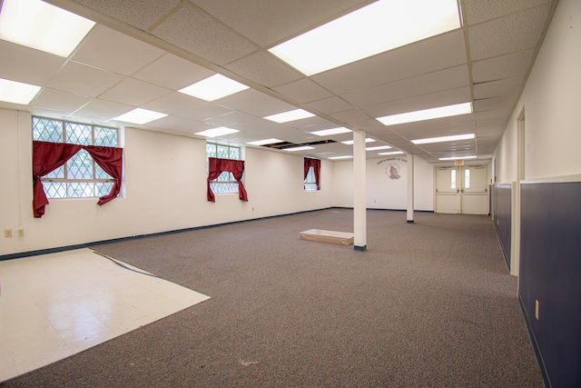 exercise area with a paneled ceiling and carpet flooring