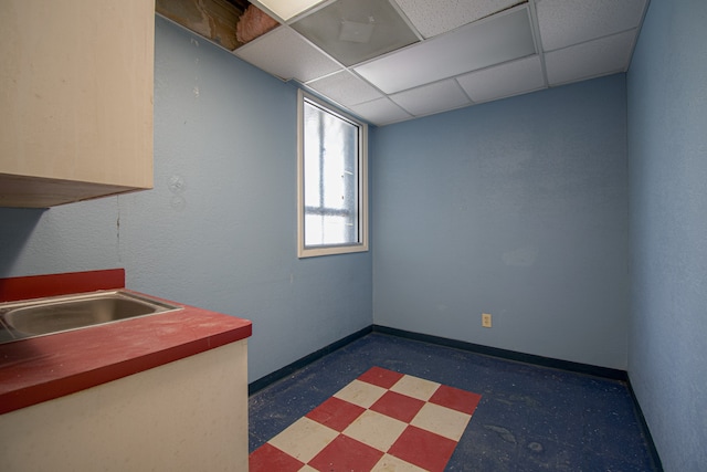 kitchen featuring a paneled ceiling and sink