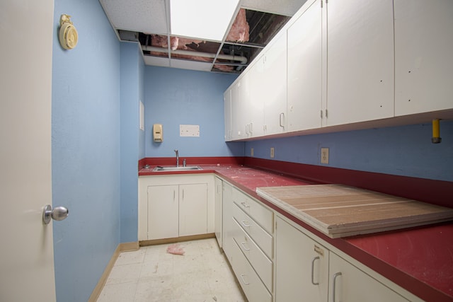 kitchen featuring sink and white cabinets