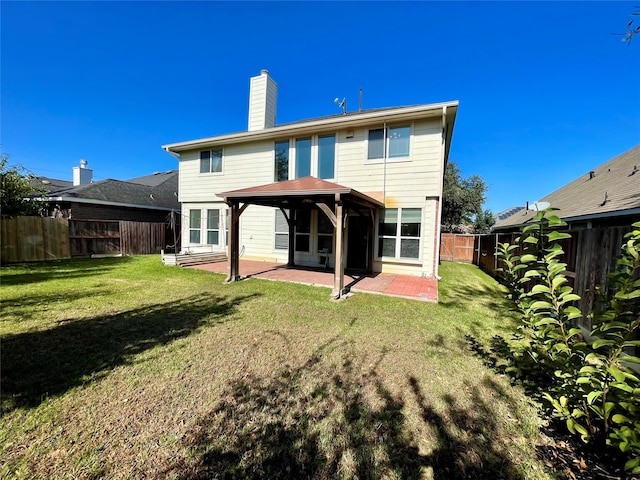 rear view of house with a patio area and a yard