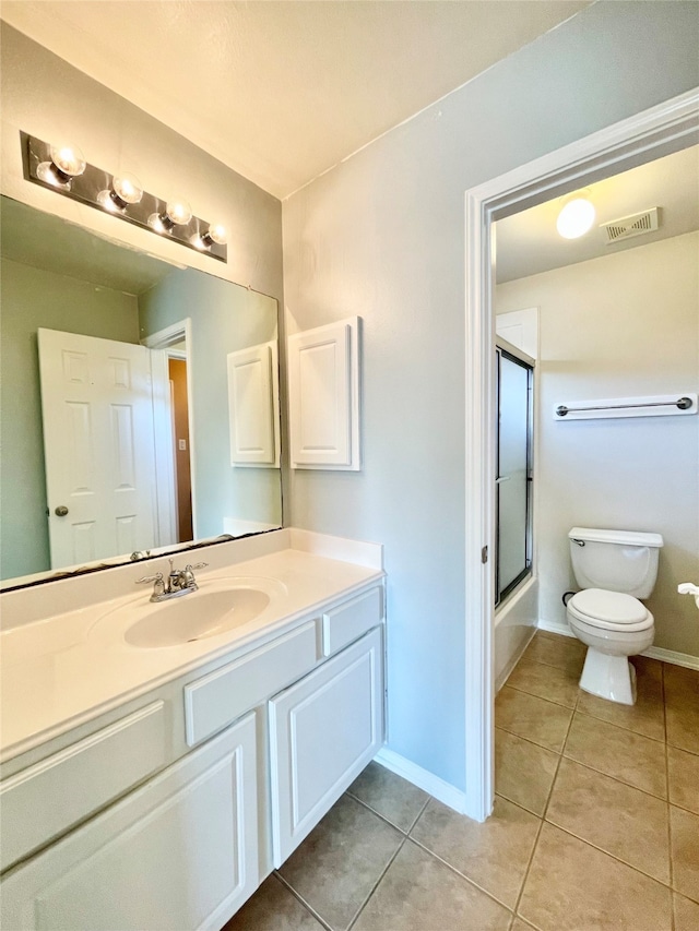 full bathroom with tile patterned flooring, vanity, toilet, and shower / bath combination with glass door