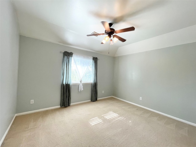 unfurnished room featuring ceiling fan, lofted ceiling, and light carpet