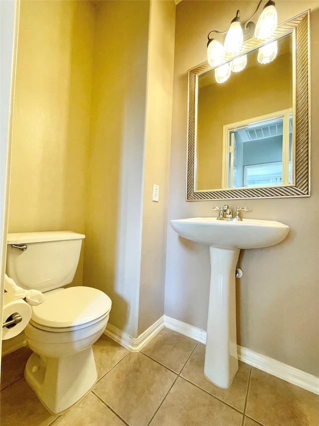 bathroom with tile patterned floors and toilet